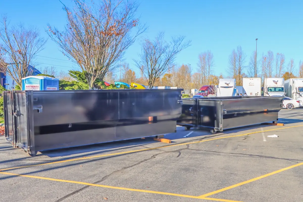 Professional dumpster rental service with roll-off container on residential driveway in Port LaBelle